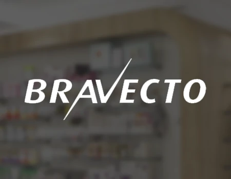 Miniatura de projeto em realidade aumentada (AR) da Bravecto, com logotipo branco centralizado sobre fundo desfocado de farmácia/pet shop.